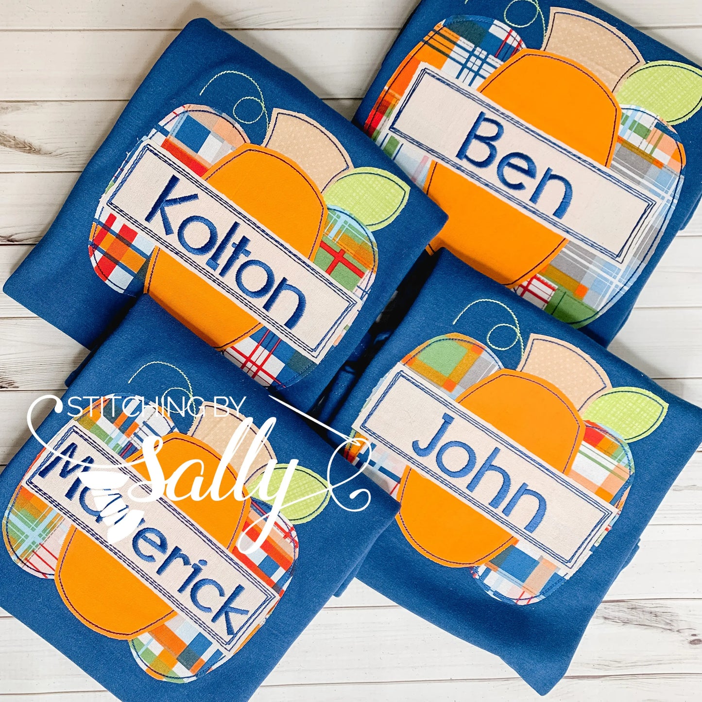 Group of four boys' navy shirt with orange and plaid pumpkin appliqué