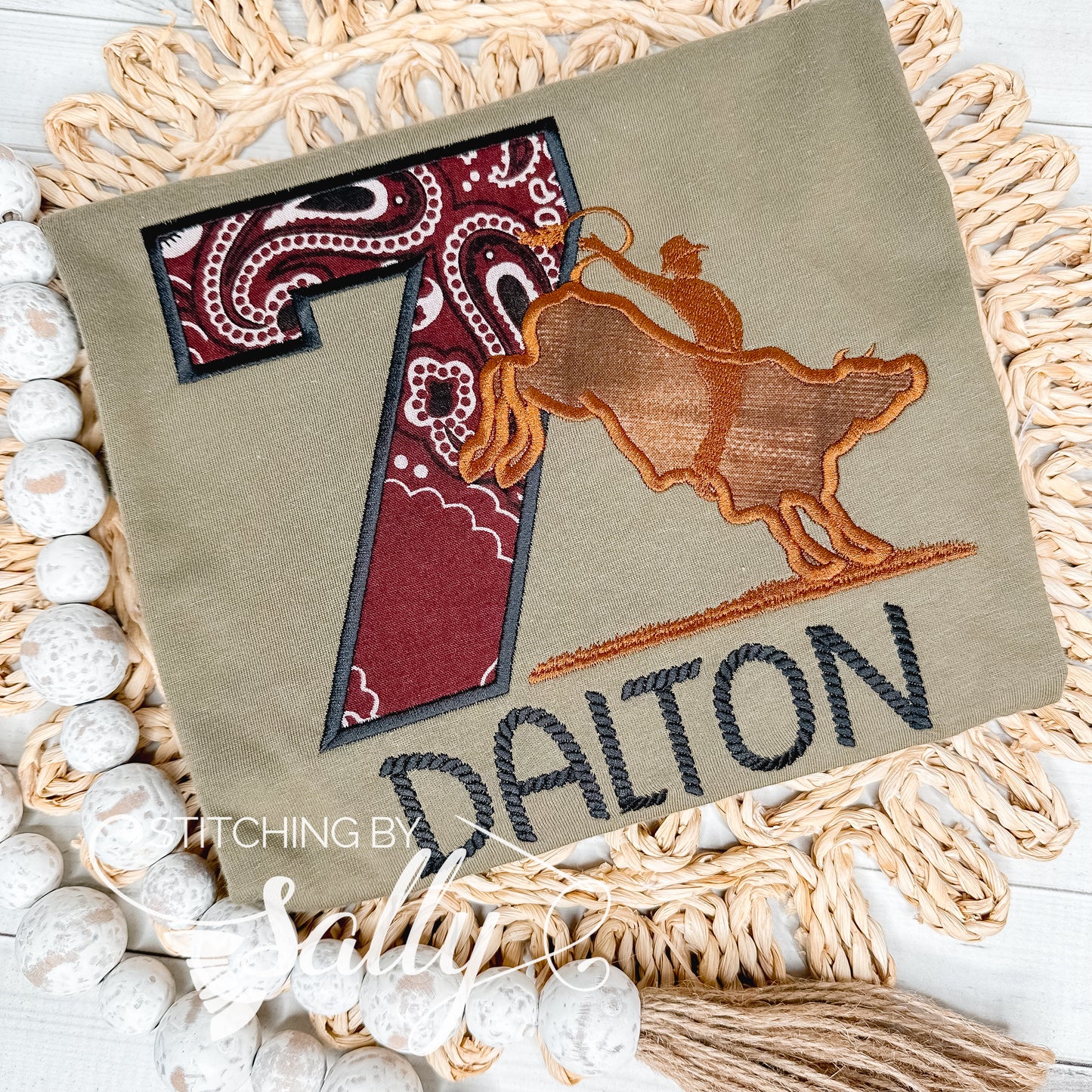 Green birthday shirt with a brown bucking bull rider appliqué design, capturing the dynamic movement of the bull in a playful and festive style. Personalized with custom birthday number and name.