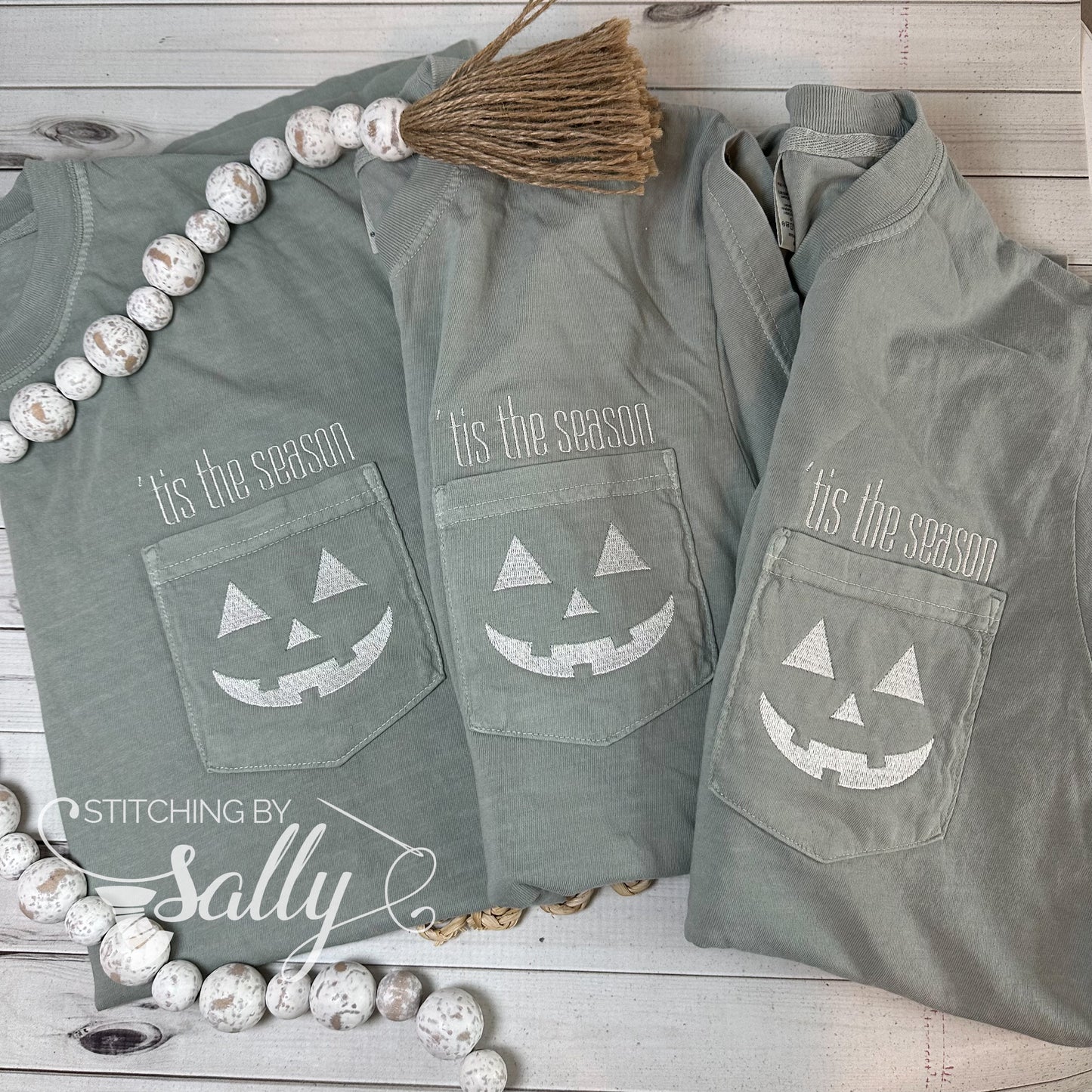 A group of three shirts with a Halloween design embroidered on the pocket