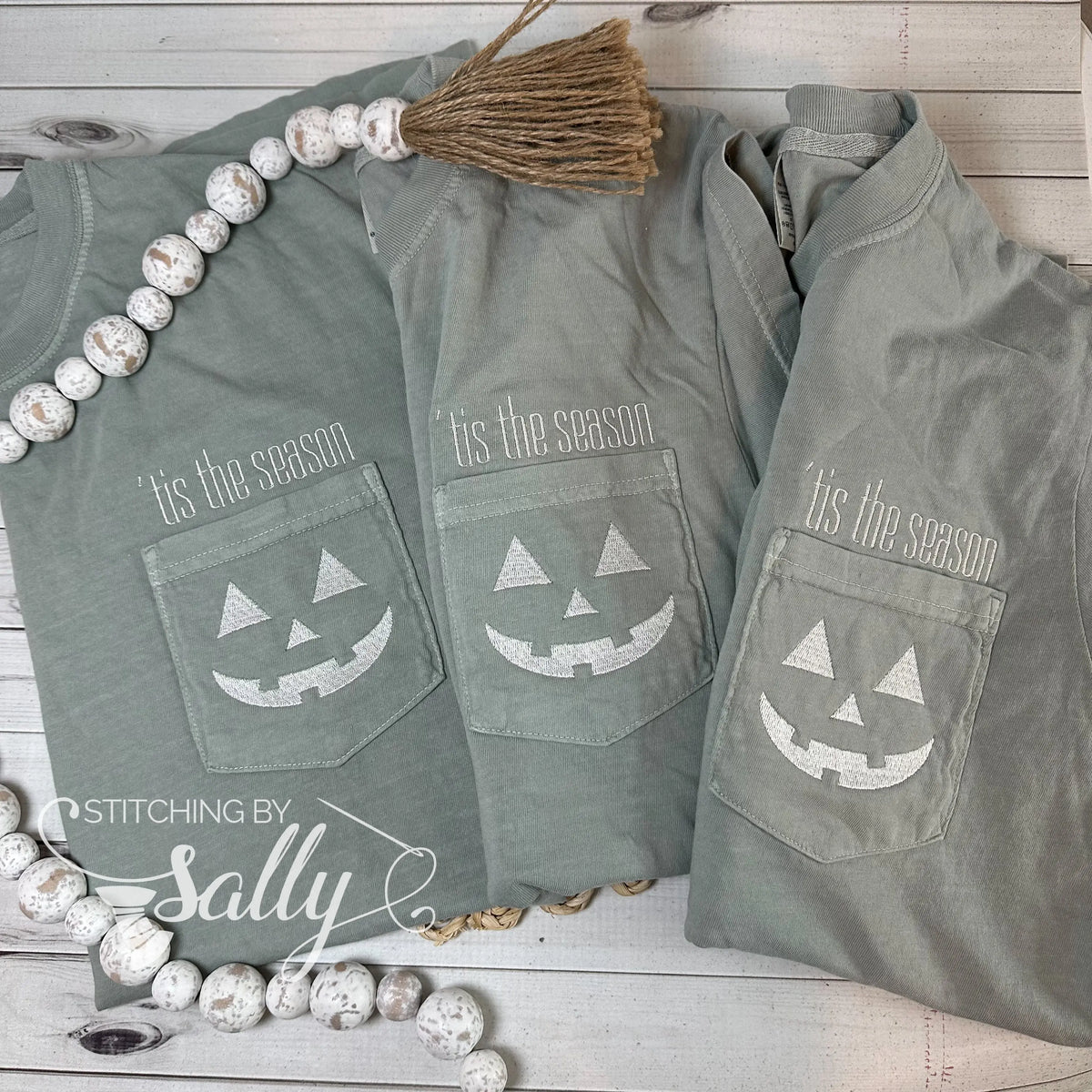 A group of three shirts with a Halloween design embroidered on the pocket