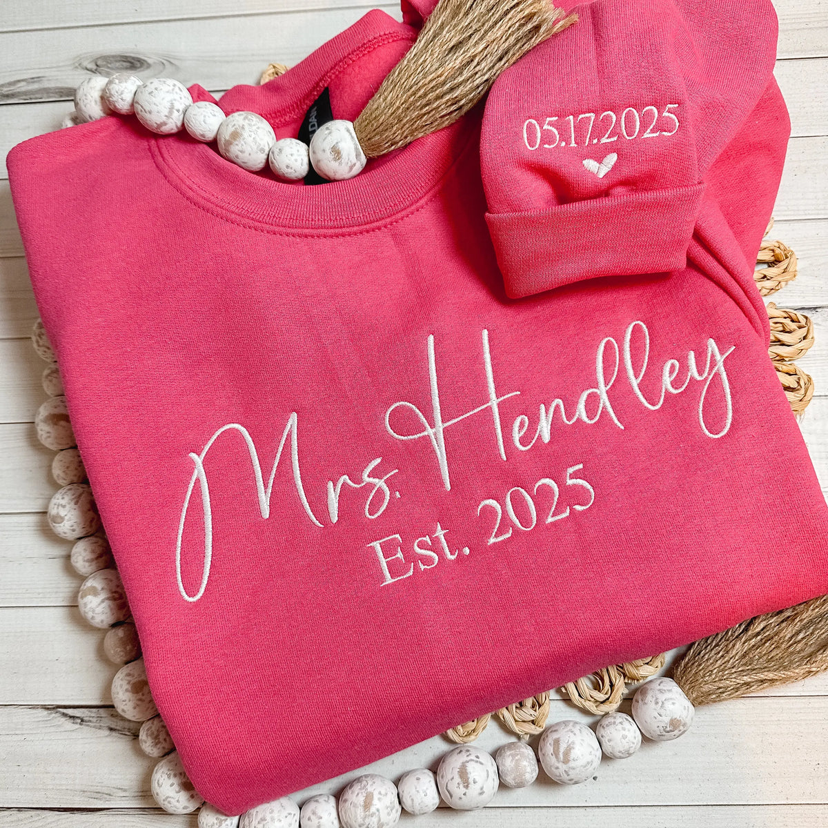 Flat lay of a Mrs. sweatshirt embroidered with new last name. Choose sweatshirt color and thread color.