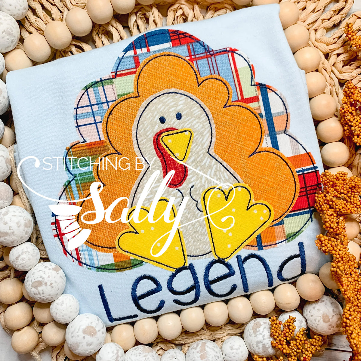 Flat lay of boys' fall turkey shirt with plaid applique and personalized name