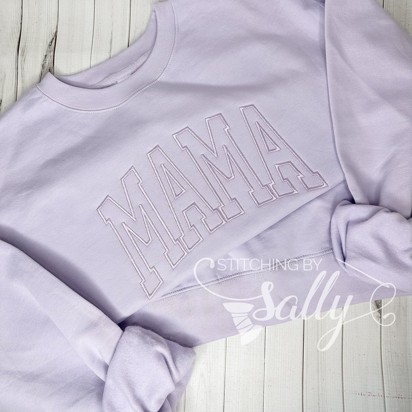 Cozy lavender mom sweatshirt folded neatly on a neutral background