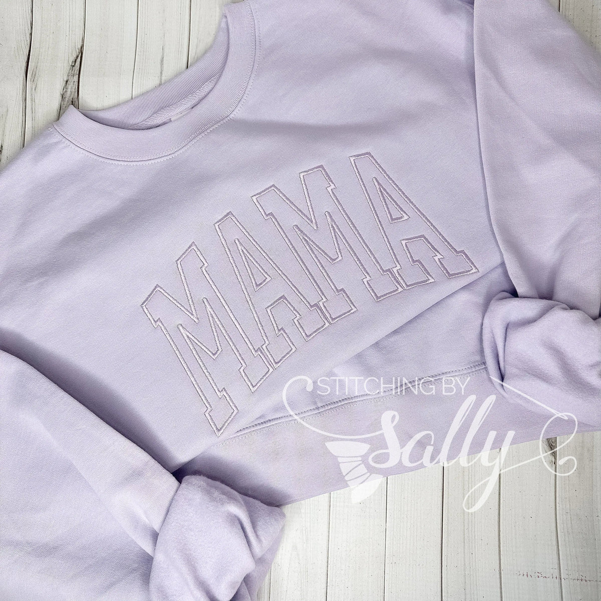Cozy lavender mom sweatshirt folded neatly on a neutral background