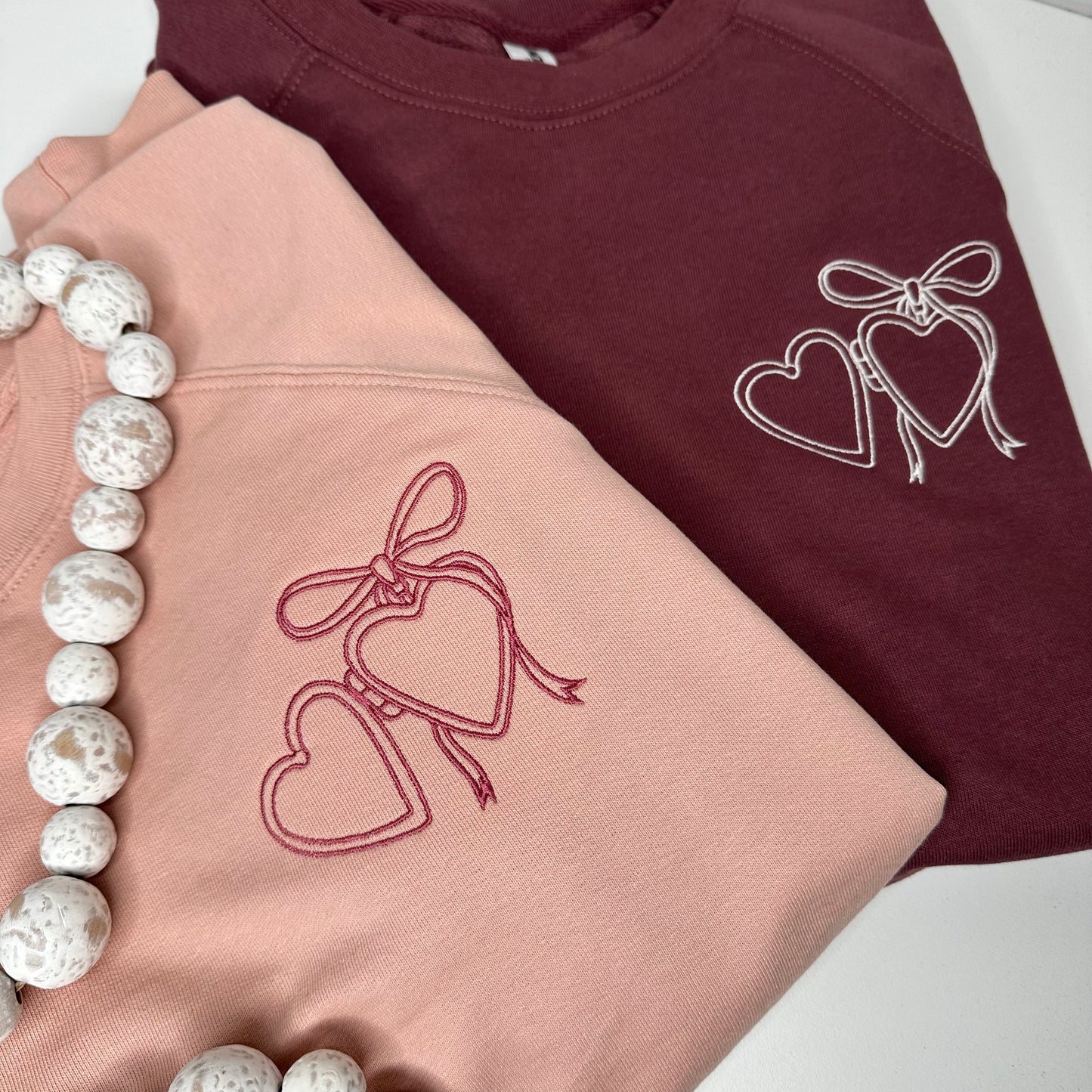 Heart locket embroidered on left chest of independent trading co sweatshirt.