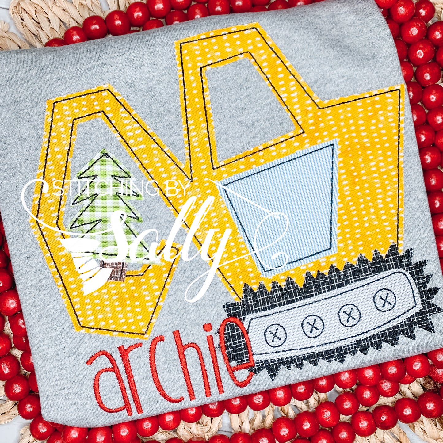 Excavator Applique design on a grey shirt for boys.