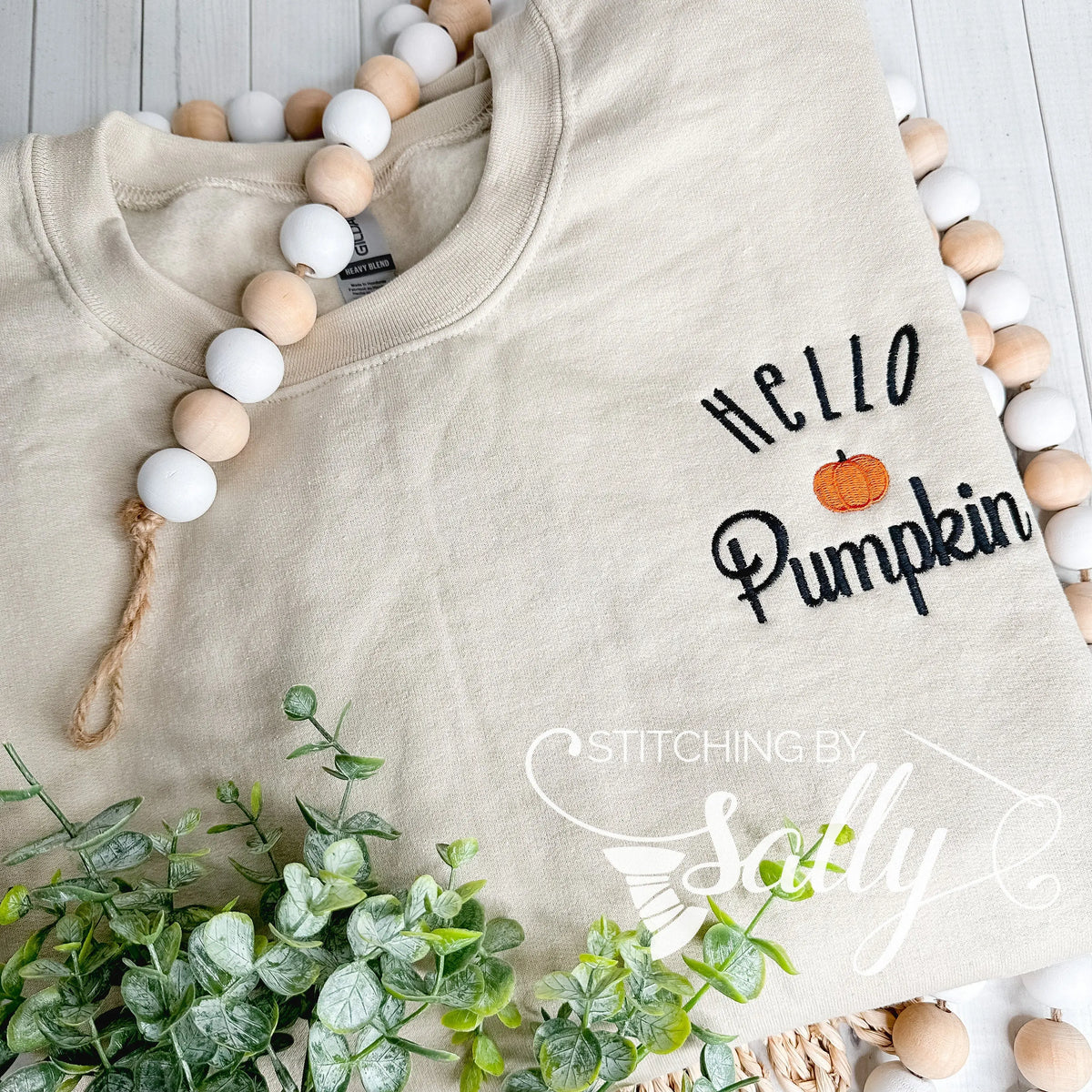 Flat lay of Gildan sweatshirt with Hello Pumpkin embroidered on the left chest.