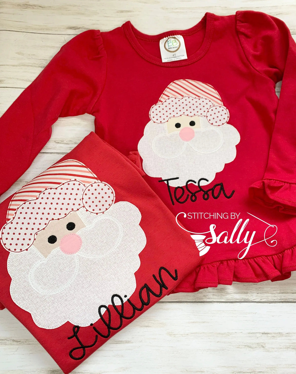 Matching red girl shirts with a santa face applique in red and white fabric. Personalized with name in black thread.