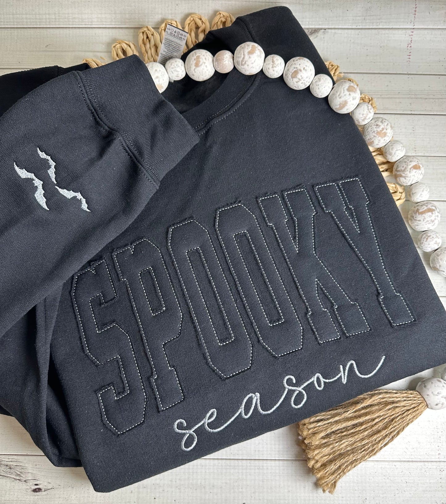 Close-up of black-on-black lettering made from sweatshirt material