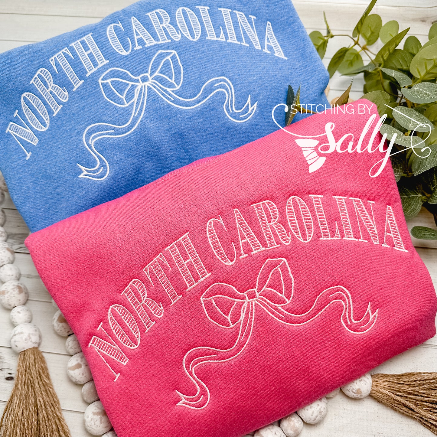 Striped North Carolina embroidered sweatshirt with a coquette bow, available in custom sweatshirt and thread colors.