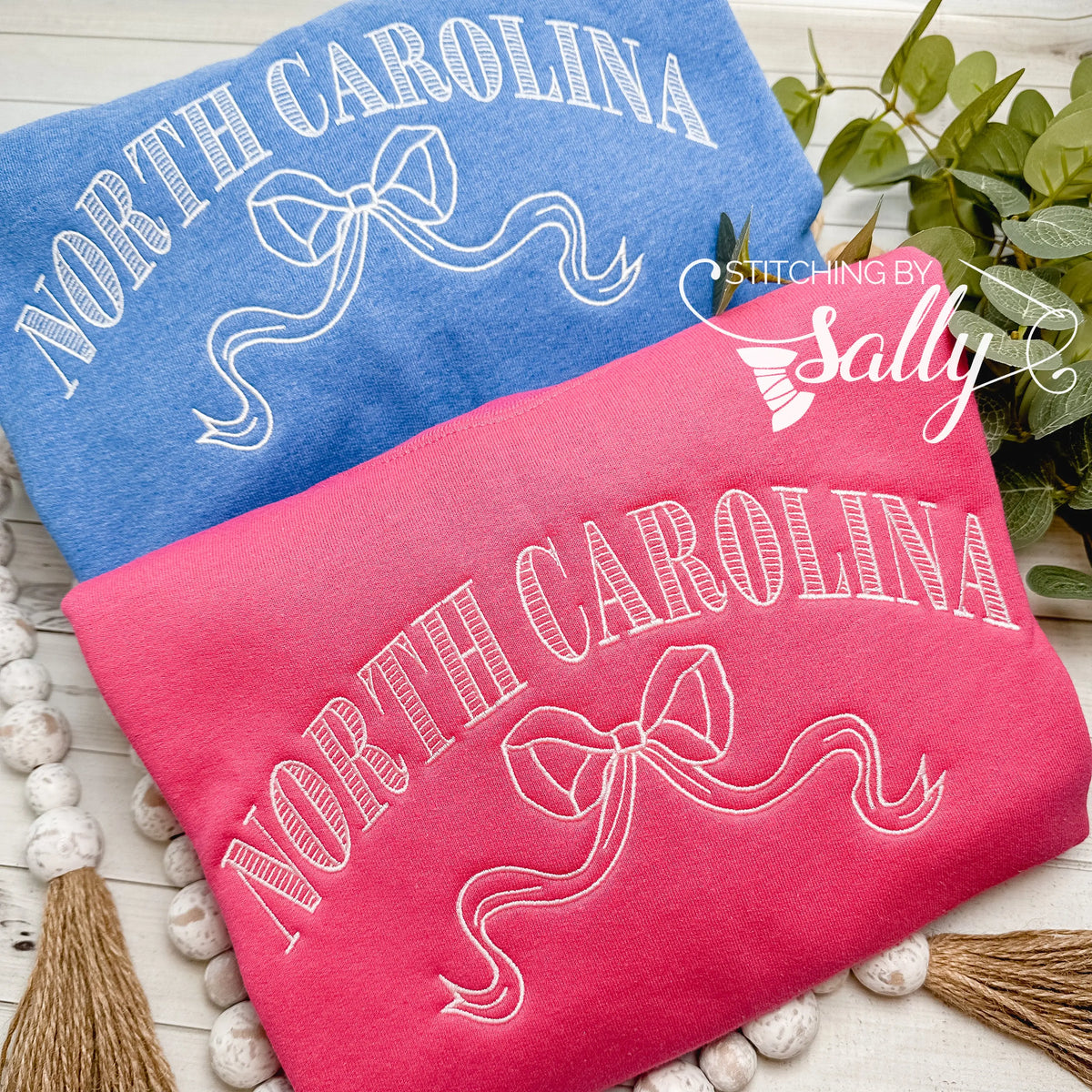 Striped North Carolina embroidered sweatshirt with a coquette bow, available in custom sweatshirt and thread colors.