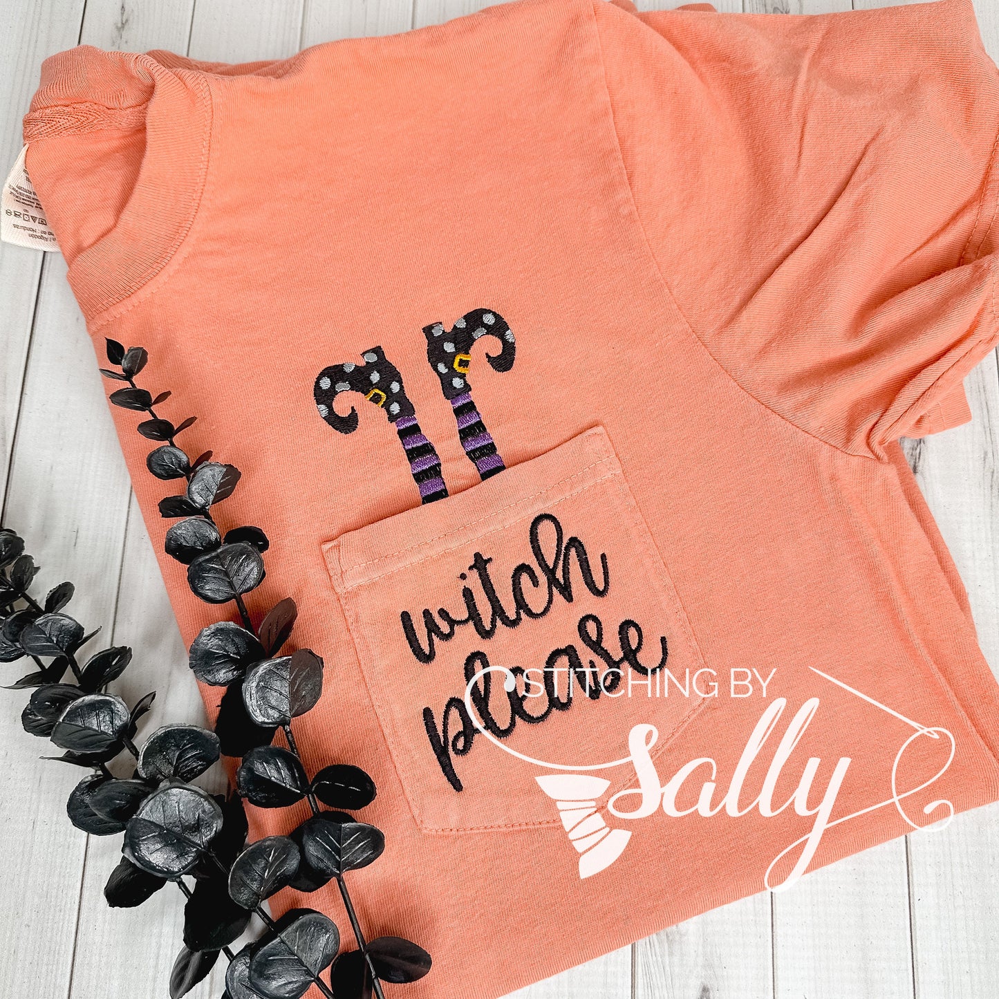 Comfort Colors pocket t-shirt with “Witch Please” embroidered on pocket with legs sticking out.