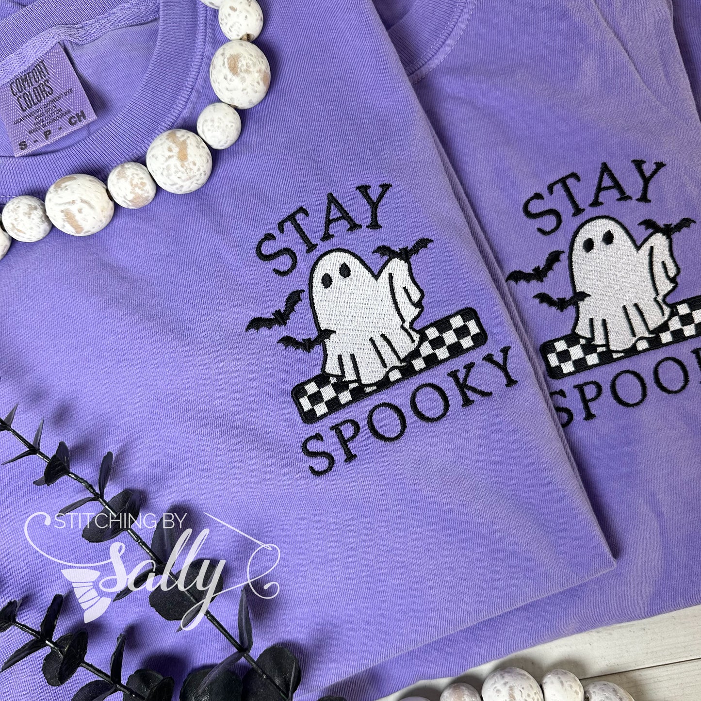 Ghost and bats embroidered design on purple shirt