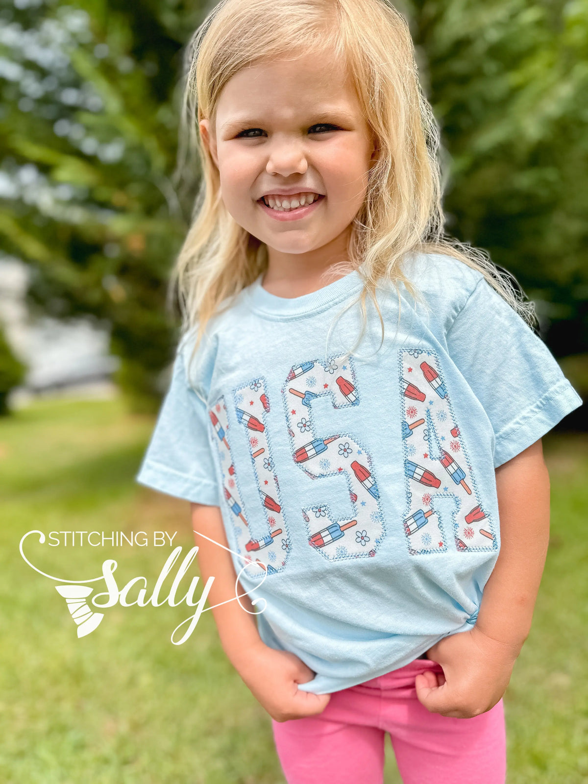 Little girl wearing the oversized USA applique shirt