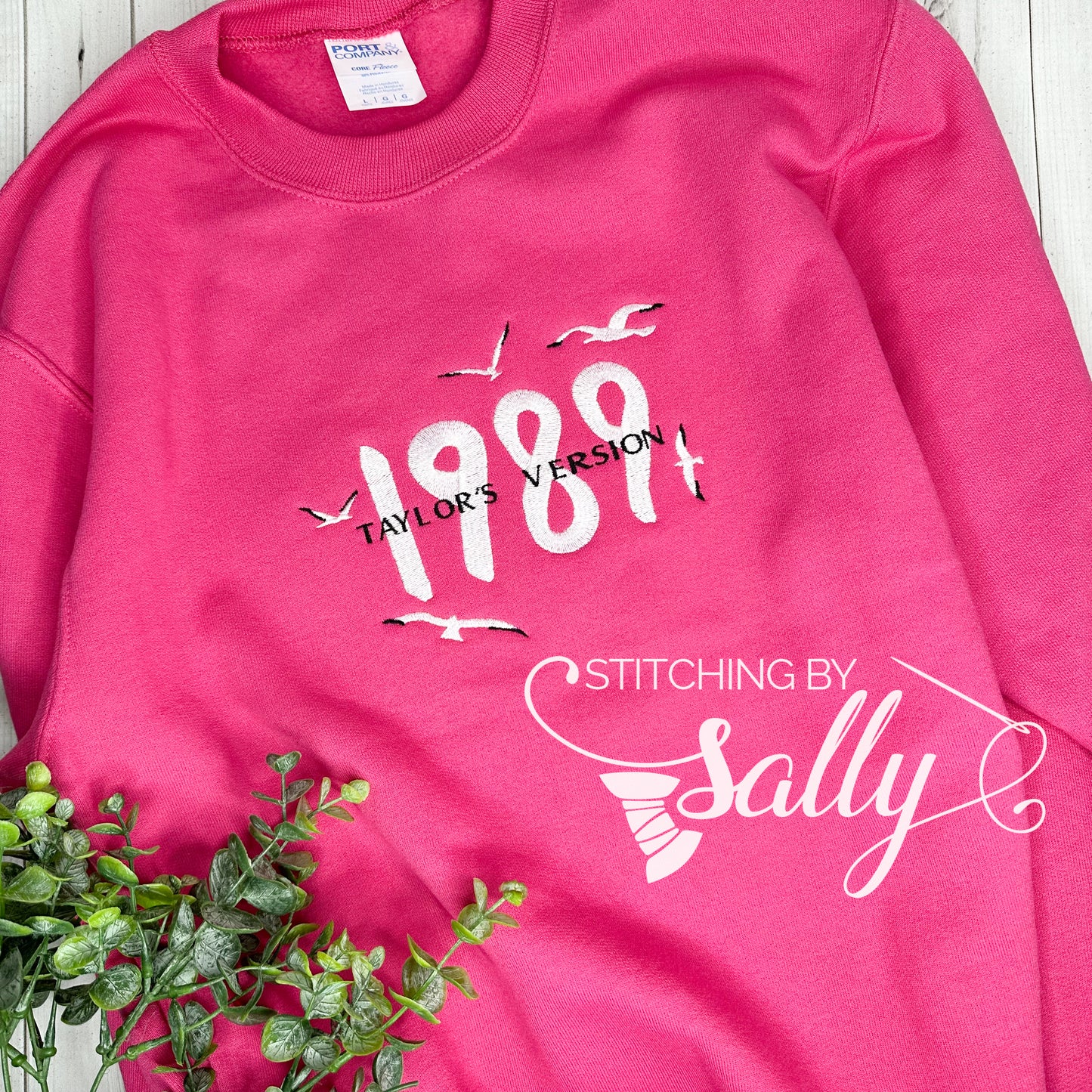 Hot pink 1989 embroidered sweatshirt inspired by Taylor Swift’s album, soft unisex crewneck with minimalist design.