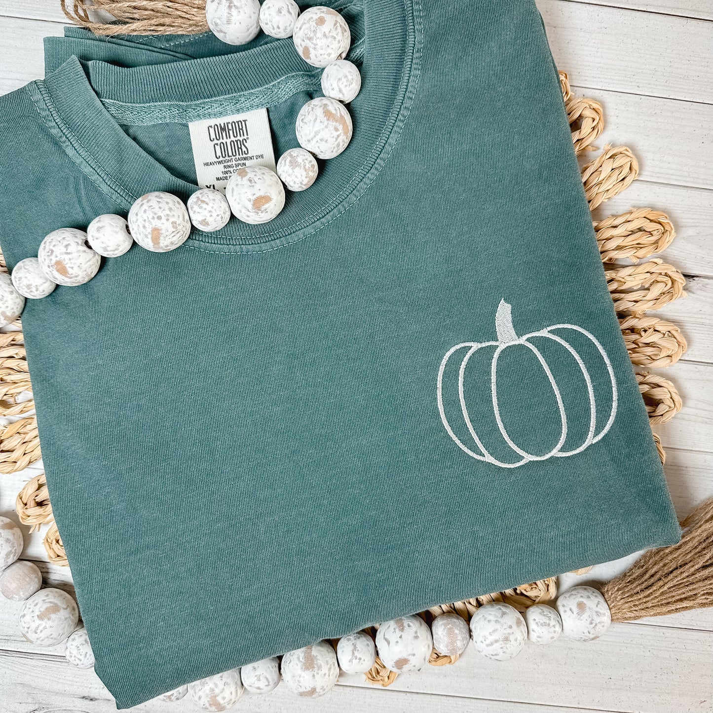 Blue Spruce shirt with a pumpkin embroidered in cream thread.