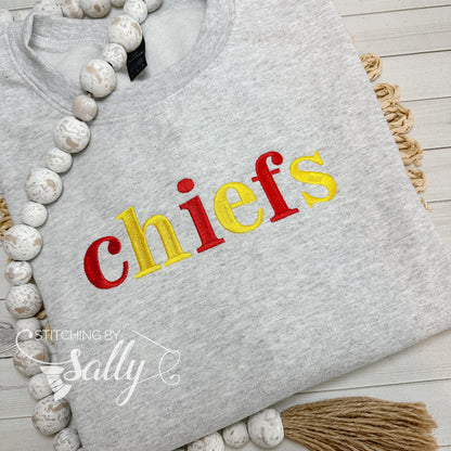 Grey Gildan sweatshirt with embroidered chiefs text in red and yellow