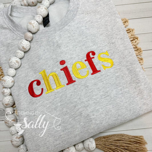 Grey Gildan sweatshirt with embroidered chiefs text in red and yellow