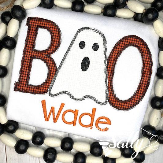Close-up of stitched ghost and BOO design on Halloween shirt. Name embroidered underneath