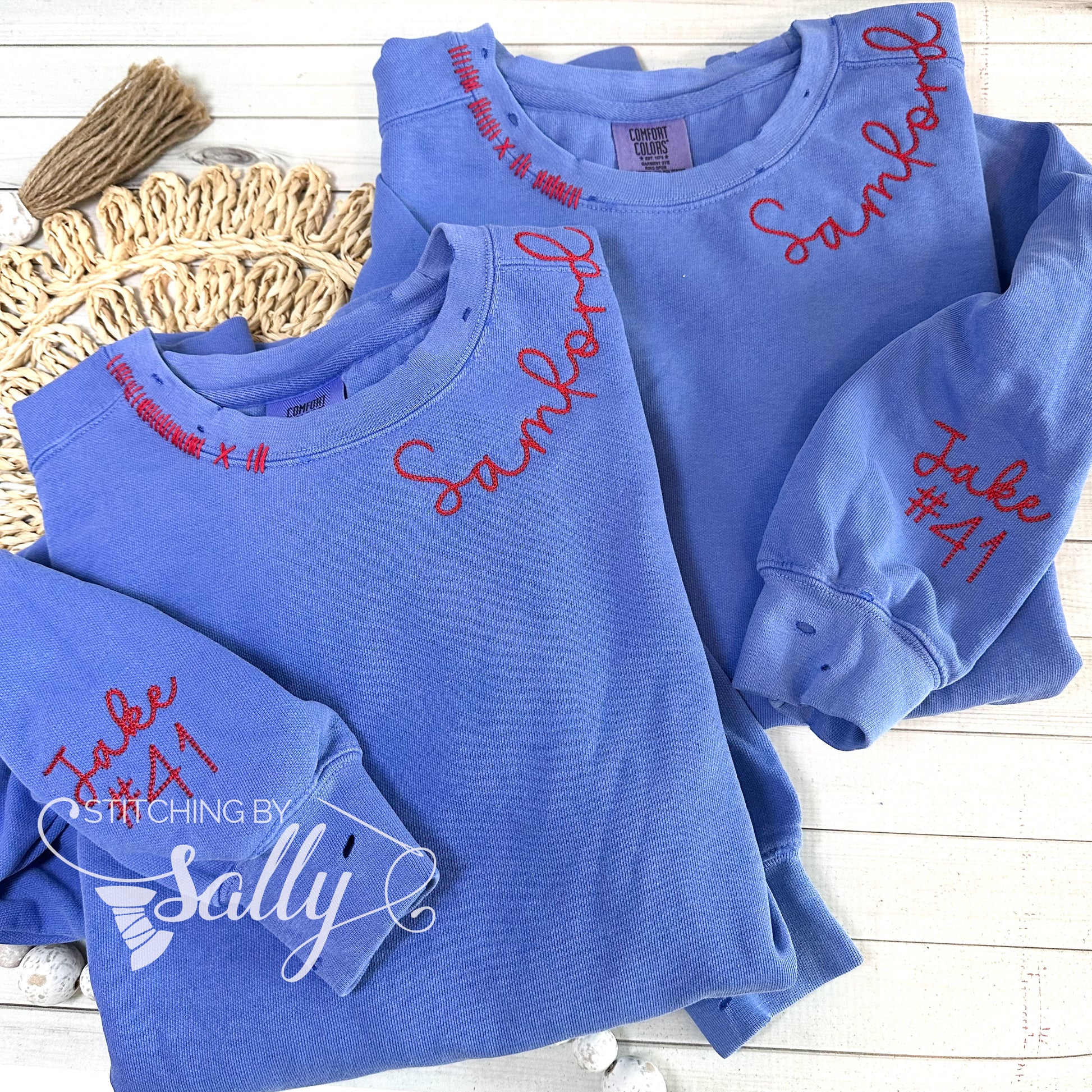 Hand-distressed embroidered crewneck with personalized team name around neckline and players name and number on sleeve