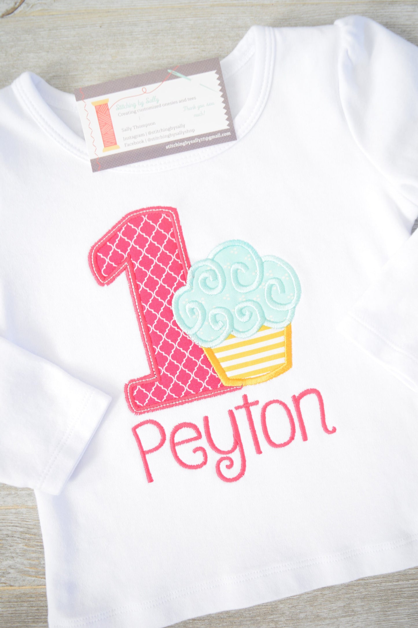 Girls cupcake first birthday appliqué shirt with embroidered number one, perfect for cake smash and party celebrations.