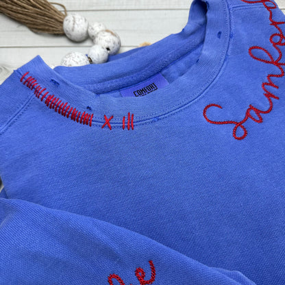 CLose up of neckline stitching and hand distressing