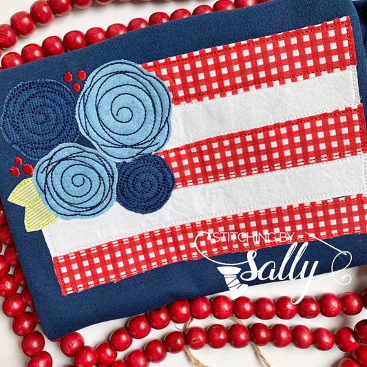 Girls floral flag appliqué shirt with embroidered American flag, perfect for 4th of July celebrations.