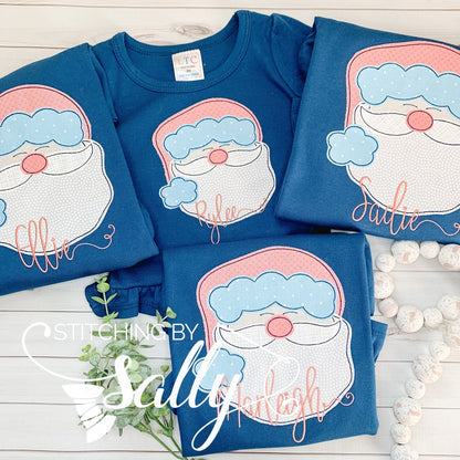 Four navy shirts with a santa face appliquéd using pink fabric for the hat.
