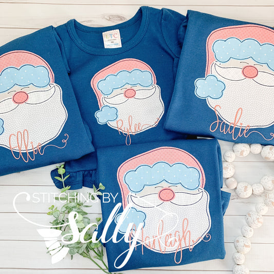 Four navy shirts with a santa face appliquéd using pink fabric for the hat.