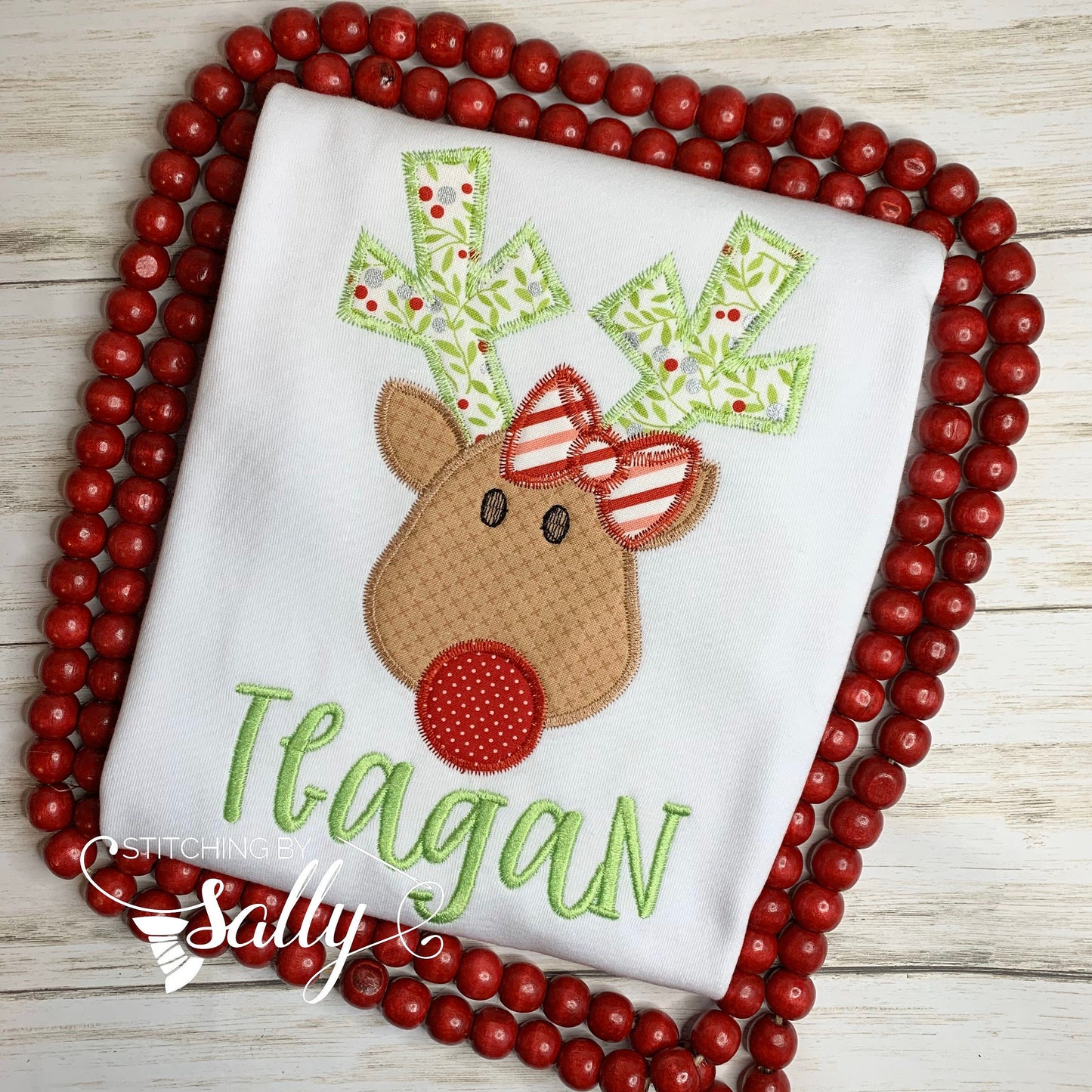 Close up of reindeer applique with bow shirt design