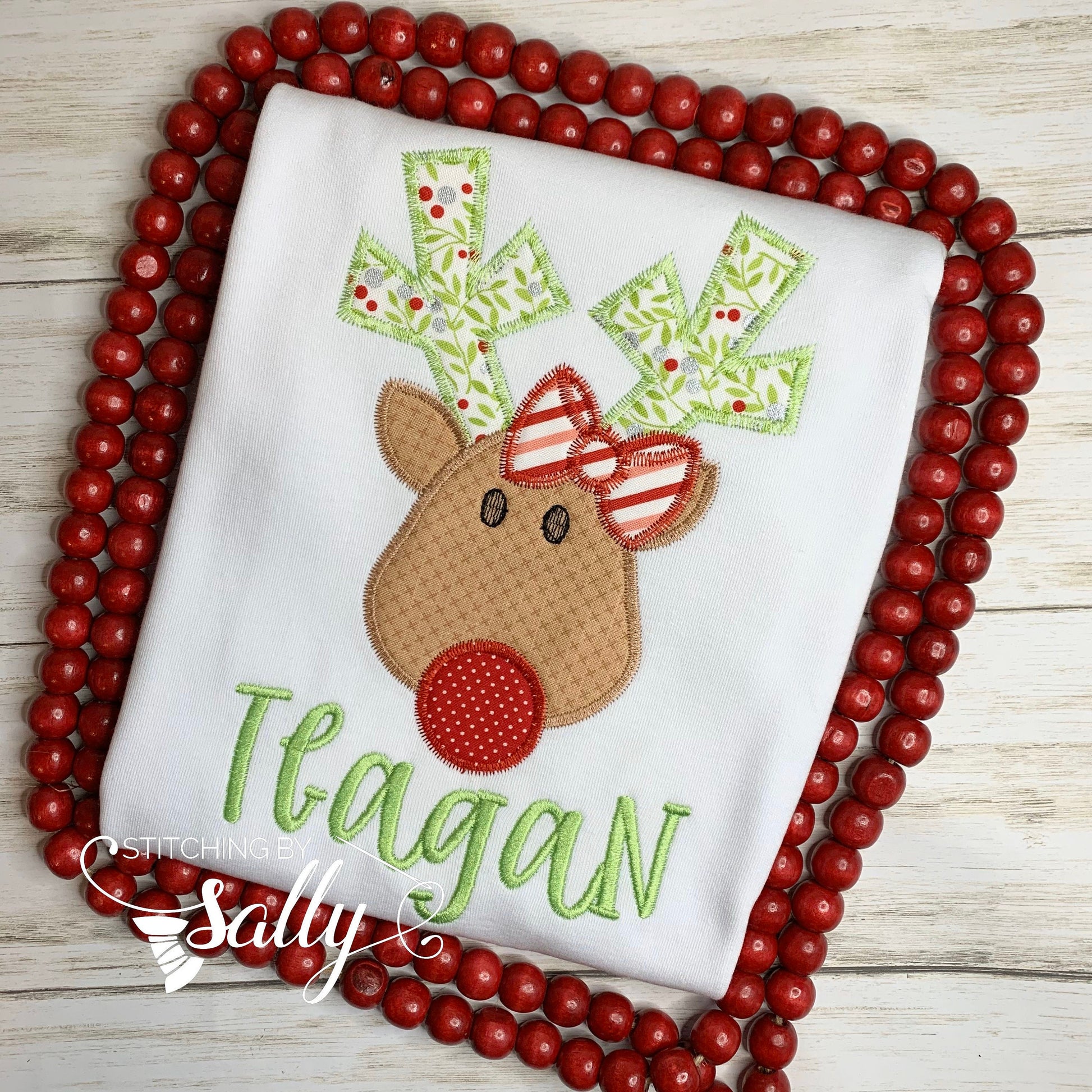 Close up of reindeer applique with bow shirt design