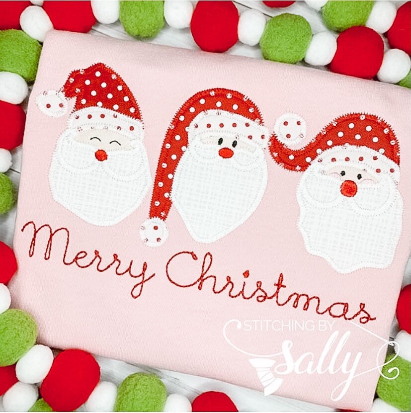 Close up of the santa trio applique on a pink shirt