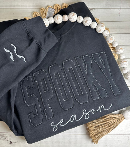 Close-up of black-on-black lettering made from sweatshirt material
