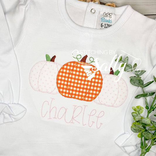 Close-up of pink polka-dot and orange gingham pumpkin design