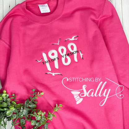 Hot pink 1989 embroidered sweatshirt inspired by Taylor Swift’s album, soft unisex crewneck with minimalist design.